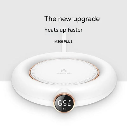 A white mug warmer with a digital temperature display and a rose gold accent. The text 'The new upgrade heats up faster M306 PLUS' is visible.