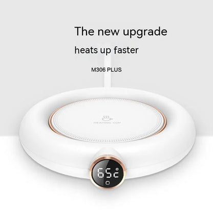 A white mug warmer with a digital temperature display and a rose gold accent. The text 'The new upgrade heats up faster M306 PLUS' is visible.