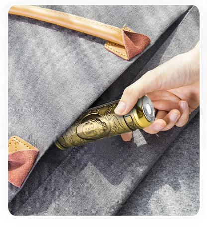 Gold pepper grinder being inserted into a gray pouch with wooden handle