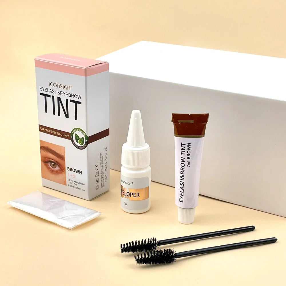 Eyelash and eyebrow tinting kit with applicator and developer on a beige background